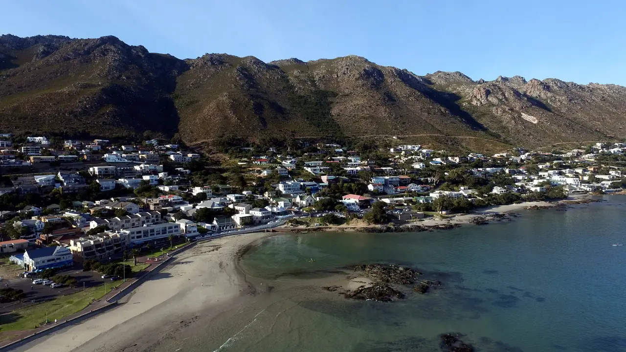 Aerial view of a sandy beach, turquoise water and mountains
